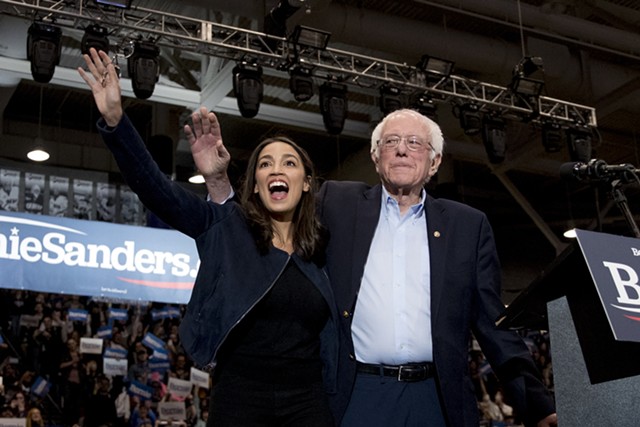 Sen. Bernie Sanders (I-Vt.) and Rep. Alexandria Ocasio-Cortez (D-N.Y.) taking the stage at the Whittemore Center Arena at the University of New Hampshire - ASSOCIATED PRESS