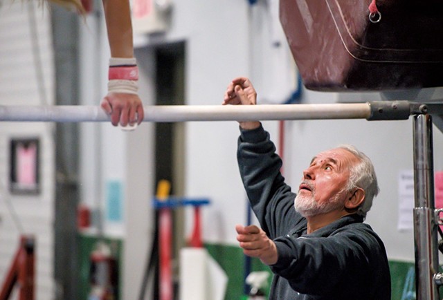 Coach Stefan Hruska working with a gymnast at the Green Mountain Training Center in Williston - GLENN RUSSELL