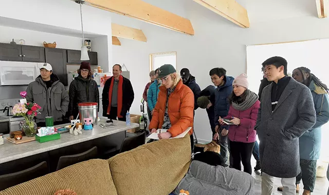 Middlebury College students from professor John McLeod's class visiting Dora Rivera's energy-efficient Habitat house - JON OLENDER