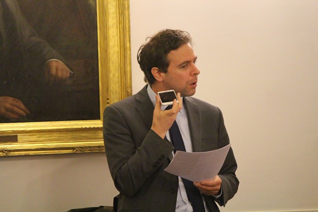 Sen. Tim Ashe conducts Senate business by phone Tuesday at the Vermont Statehouse - PAUL HEINTZ