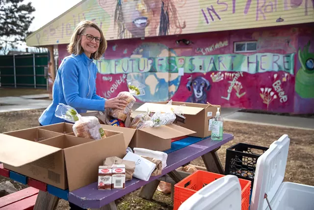 Tanya Benosky handing out food to kids in the Old North End’s Roosevelt Park - JAMES BUCK