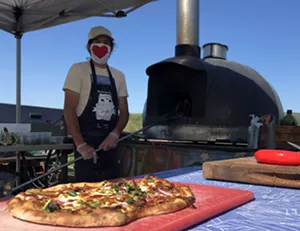 Tucker Levy mans the NOFA-VT pizza oven - JORDAN BARRY