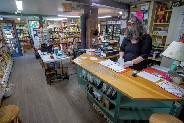 Comanager Regina Thompson checking orders at the Adamant Co-op - JEB WALLACE-BRODEUR