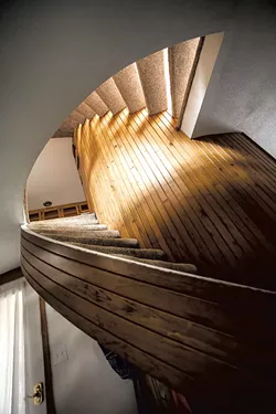 A circular staircase wraps around the central core. - TOM MCNEILL