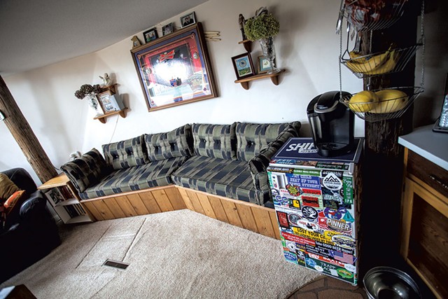 A beer fridge flanks a - built-in couch. - TOM MCNEILL