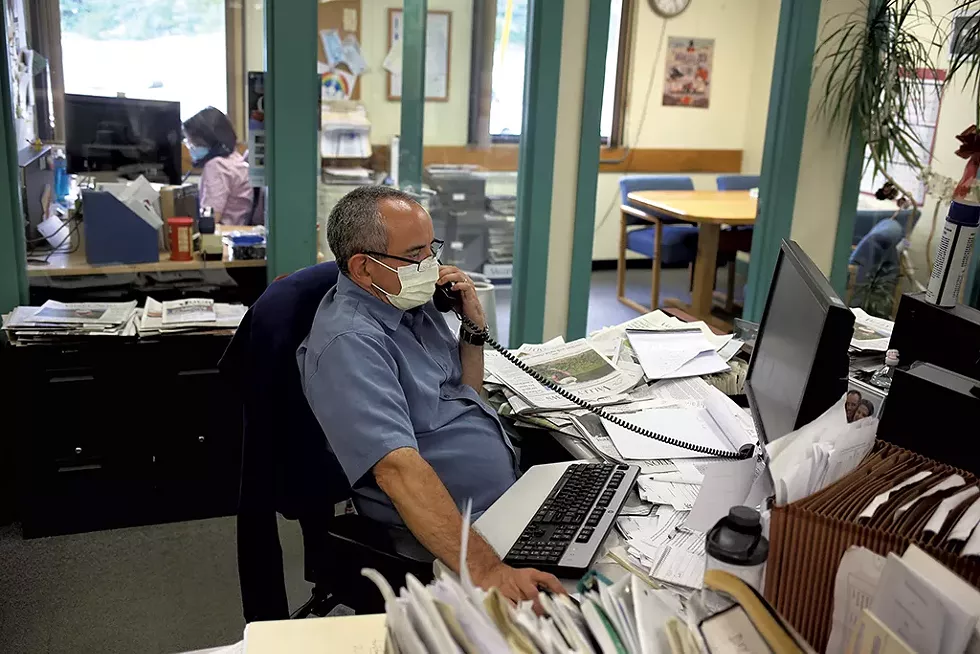 Editors John Gregg and Maggie Cassidy (in background) attending the daily news meeting by phone - SARAH PRIESTAP ©️ SEVEN DAYS