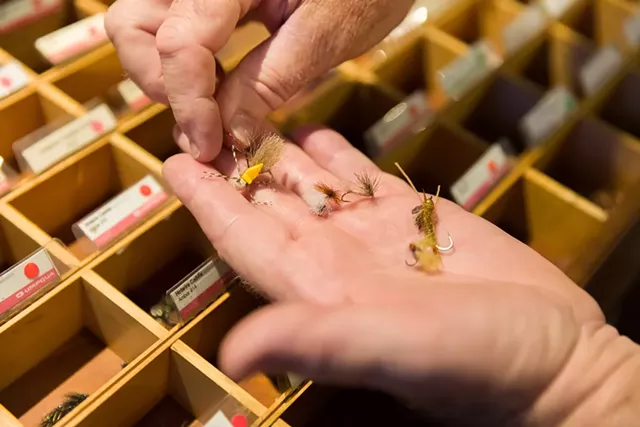 Fly Rod Shop owner Bob Shannon picking out flies for a client - OLIVER PARINI
