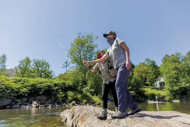 Guide Stephanie Olsen giving fly-fishing instruction in Stowe - OLIVER PARINI