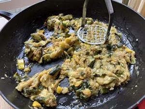 Mashing cooked zucchini and summer squash - MELISSA PASANEN ©️ SEVEN DAYS