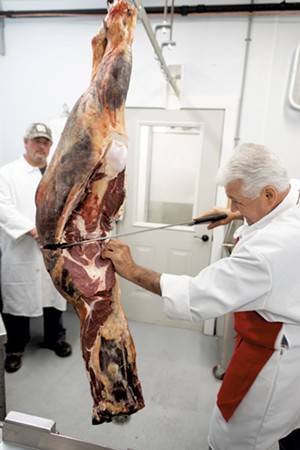Cole Ward breaking down a hindquarter of beef raised by local families for their own use - STINA BOOTH