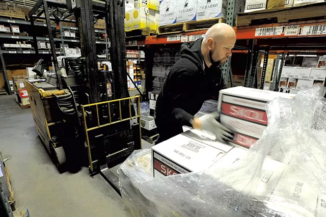 Matt Aubut unloading a pallet of vodka at the Department of Liquor Control warehouse - JEB WALLACE-BRODEUR