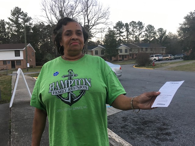 Wilhelmina Rivers holds an electricity bill after voting Saturday in Columbia, S.C. - PAUL HEINTZ