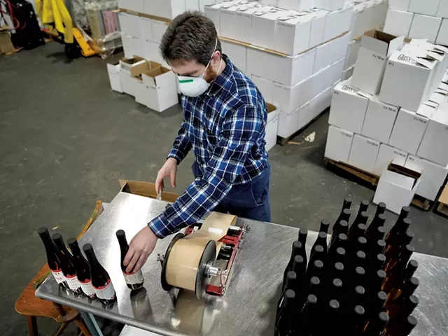 Applying labels to bottles of vermouth - DAVID SHAW