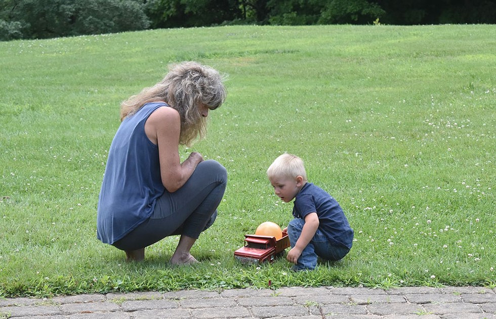 Chris Nelson interacting with a child during outside playtime - COURTESY OF CHRIS NELSON