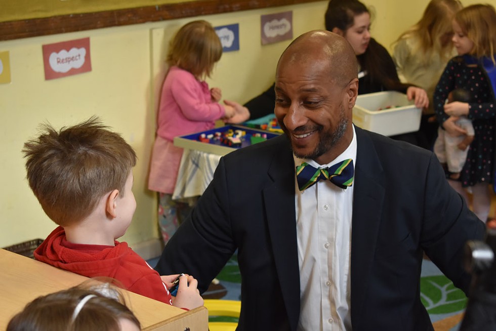 Kyle Dodson talking with a child at the Burlington YMCA - COURTESY OF THE BURLINGTON YMCA