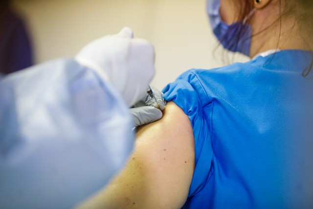 A patient receiving a vaccine dose - CATEYEPERSPECTIVE | DREAMSTIME.COM