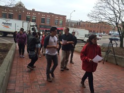 Members of Migrant Justice walk towards Sen. Patrick Leahy's Burlington office. - ALICIA FREESE