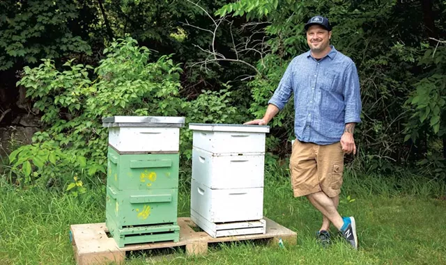 Brian Eckert with his beehives at Four Quarters Brewing - JORDAN BARRY © ️ SEVEN DAYS