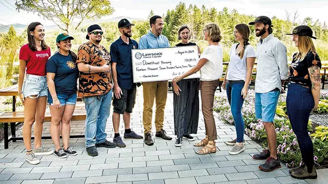 Karen Lawson presenting a check to Downstreet Housing in 2019 - COURTESY