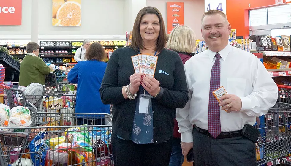 SeaComm buys groceries for 100 local residents (Branch Manager Barbara Bessette and Scott A. Wilson President and CEO) - COURTESY IMAGE