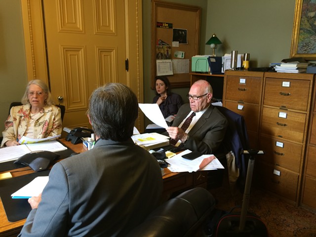 Sen. Dick Sears (D-Bennington) and Sen. Peg Flory (R-Rutland) negotiate with Rep. Chip Conquest (D-Newbury), with his back to the camera, on driver’s license-suspension legislation. - NANCY REMSEN