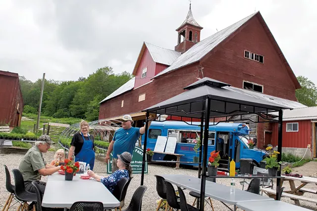 Diana and Brent Newton (standing) chatting with customers Carol Boyd and Chris Johnson at the Burger Buggy - CALEB KENNA