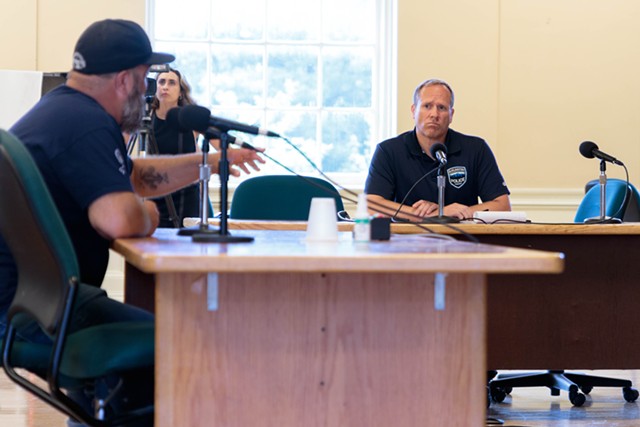 Acting police Chief Jon Murad (right) listens as former Burlington city councilor Paul Decelles speaks in favor of raising the department's staffing cap - COLIN FLANDERS ©️ SEVEN DAYS
