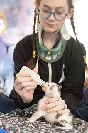 Kira feeding a foster kitten - COURTESY OF THE SERISKYS