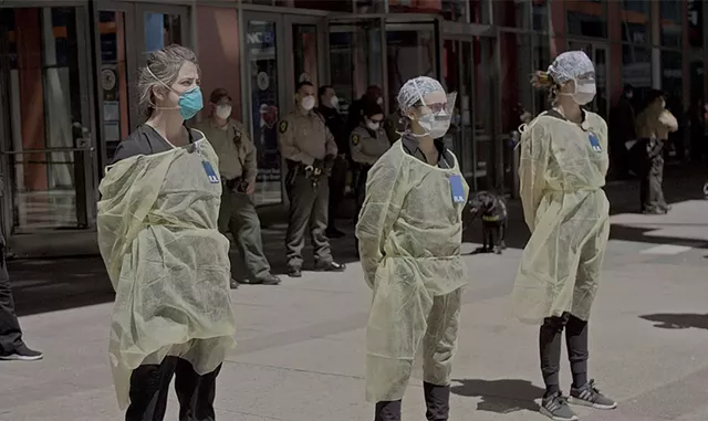 VIRAL DOUBTS Health care workers face anti-lockdown protesters in Wang's documentary about the pandemic in China and the U.S. - COURTESY OF WARNER MEDIA