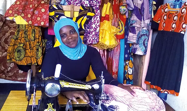 Sarah in Uganda with a sewing machine shipped from Vermont - COURTESY OF PEDALS FOR PROGRESS