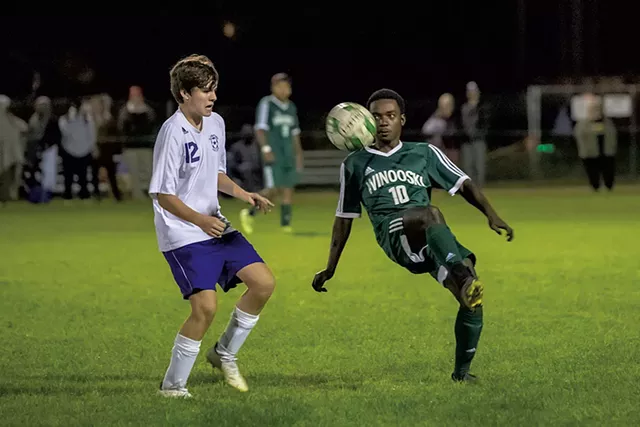 Winooski's Shabani Omar kneeing the ball during a soccer match against Oxbow High School - DARIA BISHOP