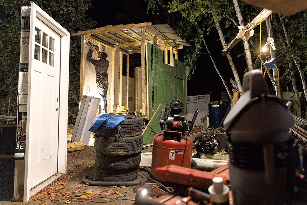 Noah working on his storage shed at the camp - JAMES BUCK