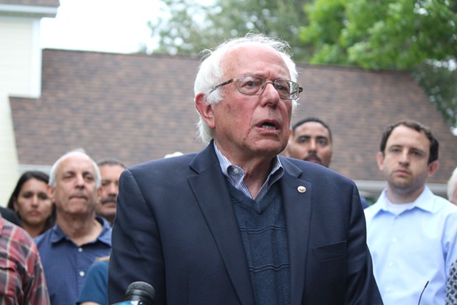Sen. Bernie Sanders addresses reporters Sunday outside his Burlington home. - PAUL HEINTZ