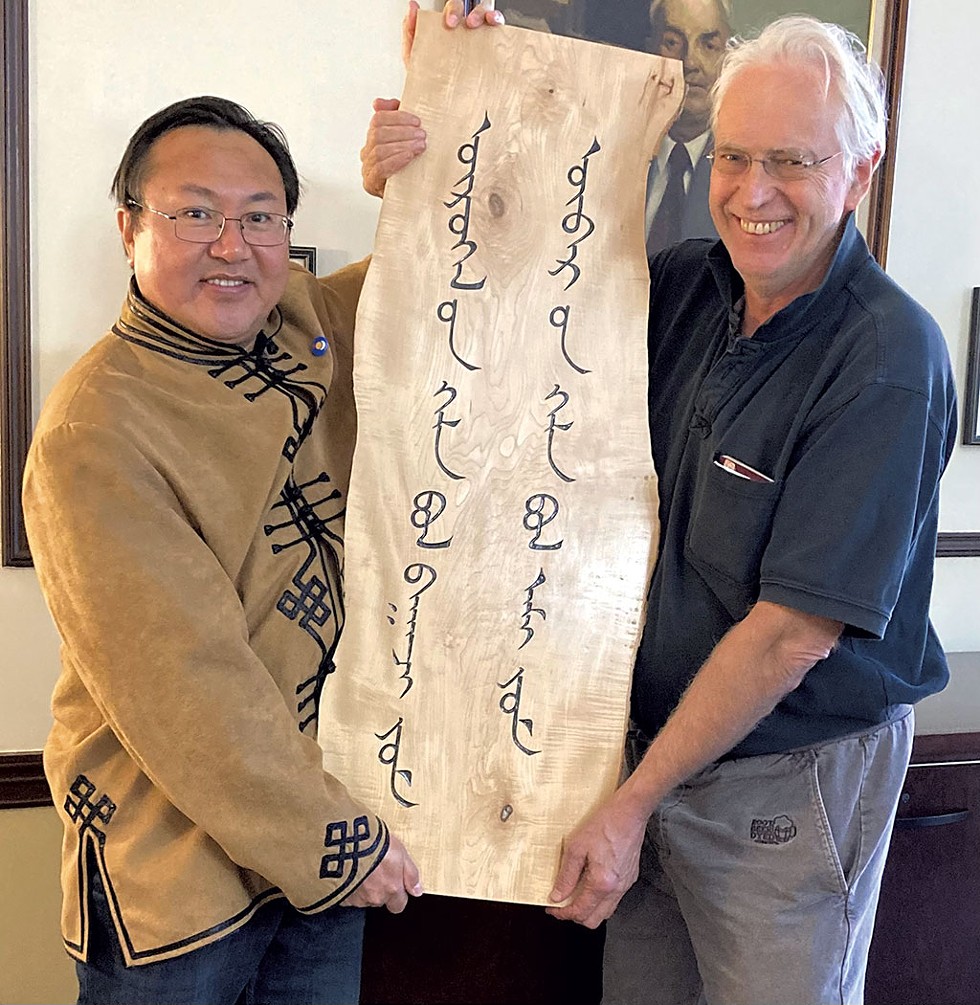 Tim Brookes presenting his wood carving to Enghebatu Togochog, director of the Southern Mongolian Human Rights Information Center - COURTESY
