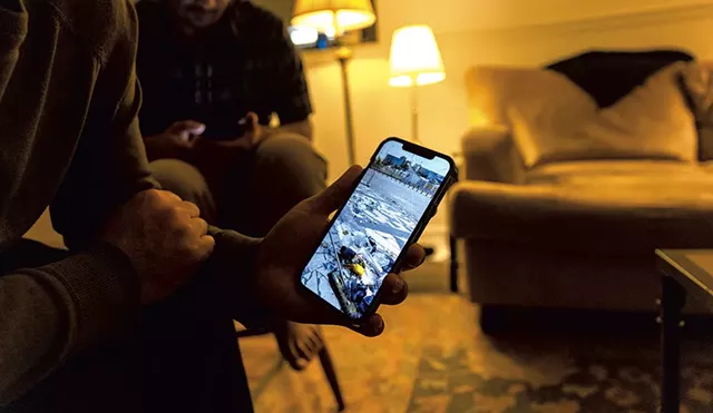 Mohammad showing a photo he took of the American side of the international airport in Kabul, Afghanistan - JAMES BUCK