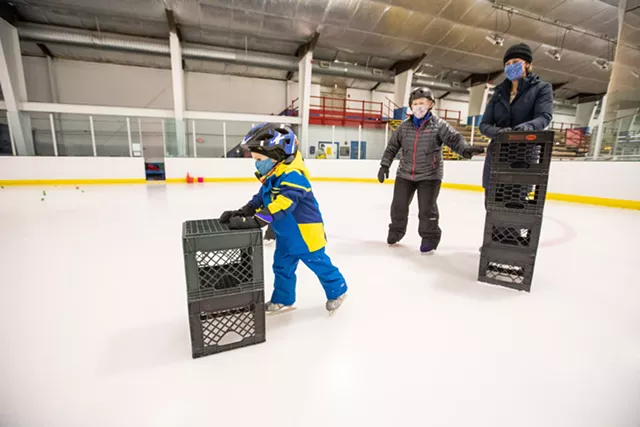 Skate instructor Julie MacDonald working with 4-year-old Liam Graziano and his mom, Jackie, from Williston. - CAT CUTILLO
