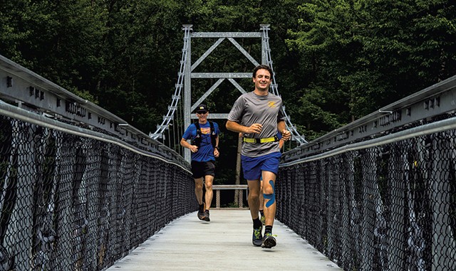 Ben Feinson crossing the Winooski River Footbridge in Bolton in July 2021 - COURTESY OF LANCE PITCHER