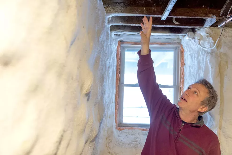 Marin shows how spray foam creates a better seal between basement ceiling joists. - JAMES BUCK