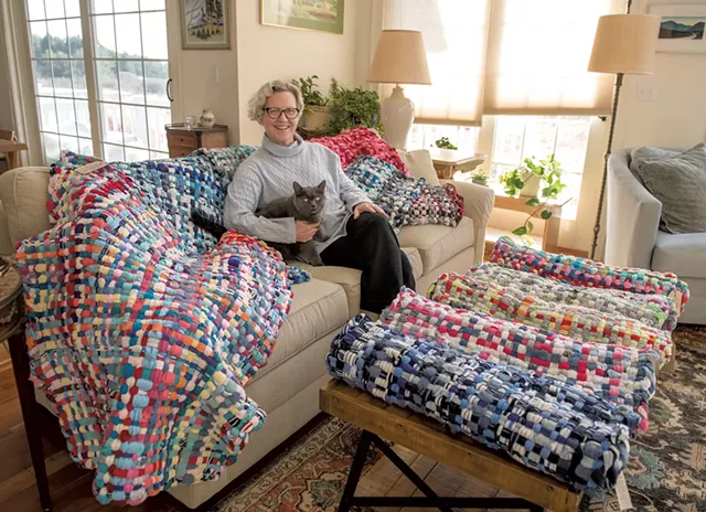 Julie Reville and her cat Cushie with some of her upcycled "potholder rugs" - DARIA BISHOP