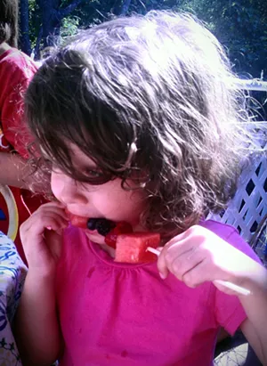 Sadie with fruit kebob - ERINN SIMON
