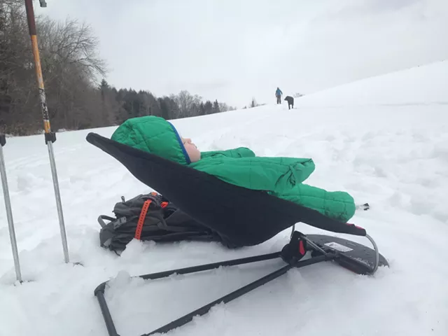 Elise hangs at base camp while her parents take turns skiing a local hill - TRISTAN VON DUNTZ