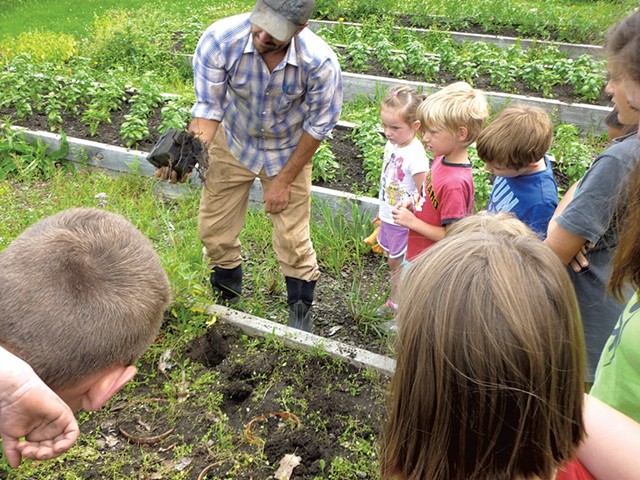 Local farmer Tucker Andrews teaching kids about the garden - COURTESY OF OCCC