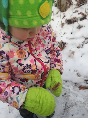 Elise checks out a flower on the side of the trail - SARAH GALBRAITH