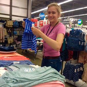 Drew Coel folding clothes at Old Navy - ANDIE PINGA