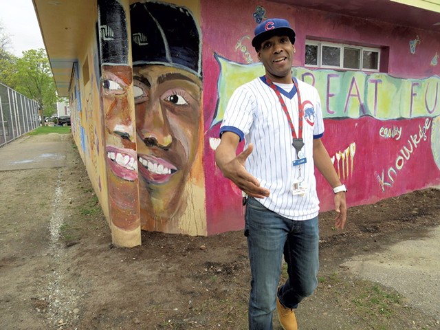Barrino in front of his portrait on the mural in Roosevelt Park - MATTHEW THORSEN