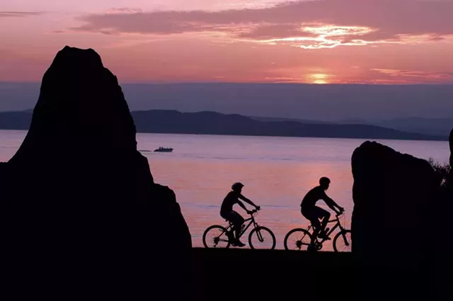 Cyclists on the Burlington Greenway at night