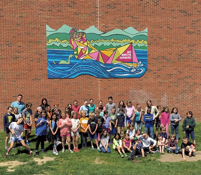 Shelburne Community School students in front of the playground mural they painted