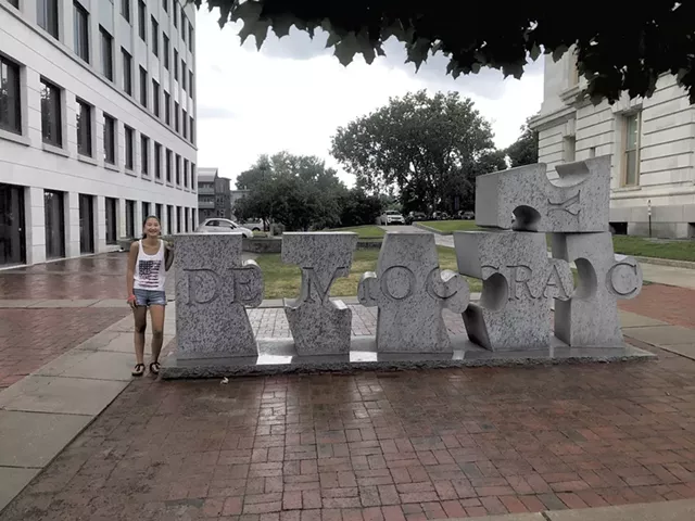 Grace Heller next to W.F. Herrick's sculpture "Democracy" in Burlington (Activity 50)