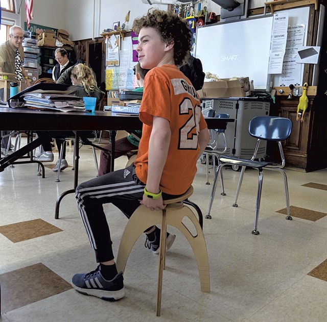A student at Edmunds Middle School tries the ButtOn Chair - COURTESY OF QOR360