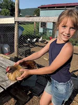 Natalie with Coco the chicken - BRETT ANN STANCIU